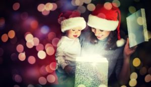  christmas magic gift box and a woman happy family mother and child baby